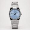 Tissot PRX 35mm watch with light blue dial and silver stainless steel bracelet.