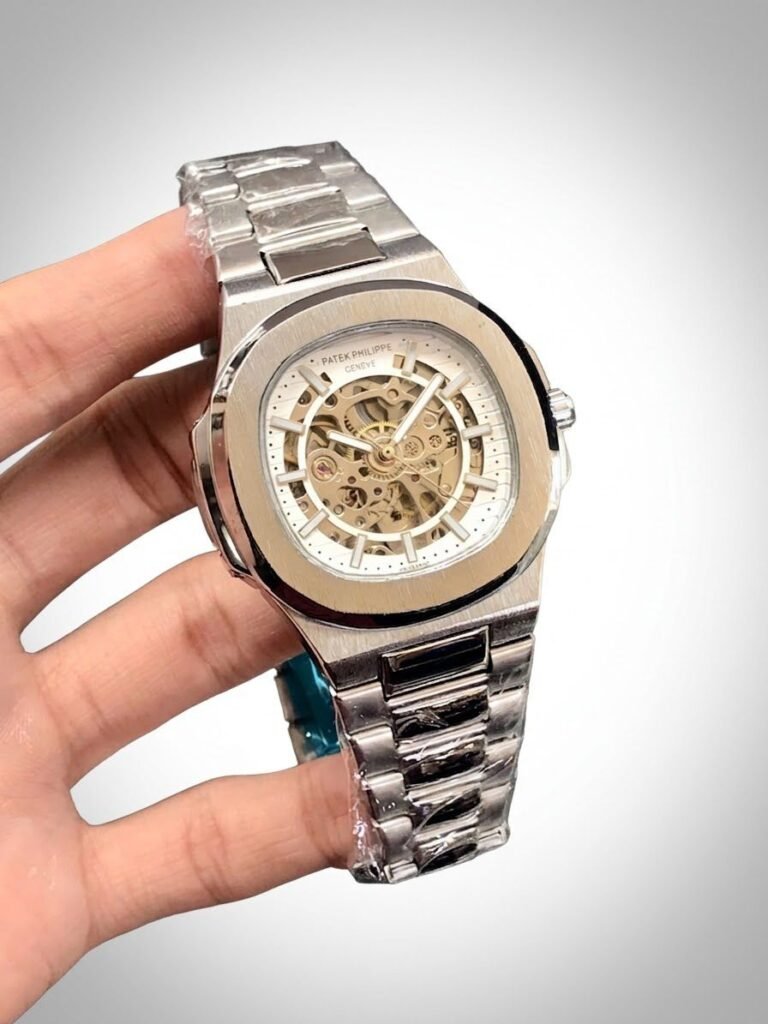 Two-tone stainless steel skeleton watch with gold bezel, silver bracelet, and exposed automatic movement.