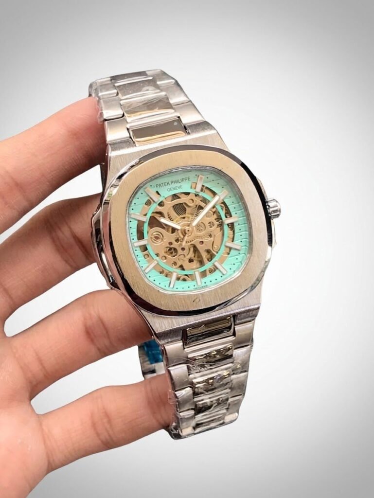 Two-tone stainless steel skeleton watch with gold bezel, silver bracelet, and exposed automatic movement.