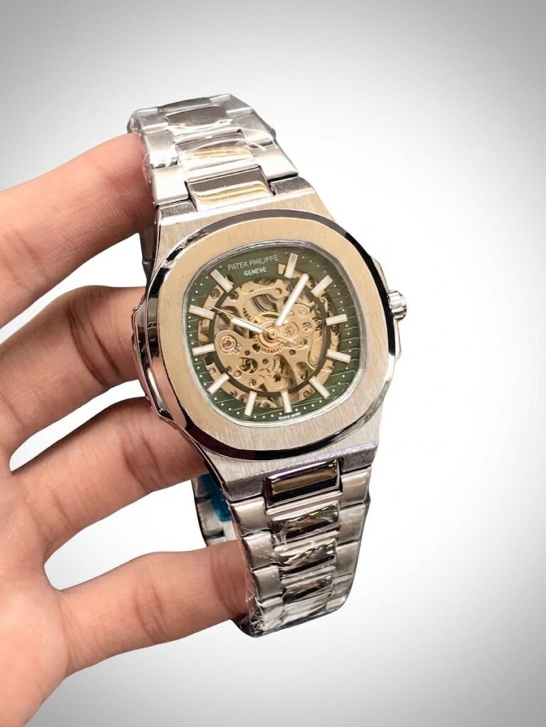 Two-tone stainless steel skeleton watch with gold bezel, silver bracelet, and exposed automatic movement.