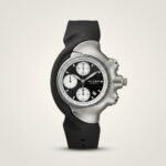 Silver sculpted Y2K style Miler watch with black dial, silver sub-dials, and black rubber strap.