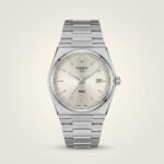 35mm unisex retro style watch with silver sunburst dial, baton indices, and integrated stainless steel bracelet.