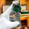 Silver-tone retro style watch with deep green sunburst dial, silver indices, and integrated steel bracelet.