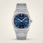 Silver-tone retro style watch with vibrant blue sunburst dial, silver indices, and integrated steel bracelet.
