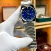 Silver-tone retro style watch with vibrant blue sunburst dial, silver indices, and integrated steel bracelet.