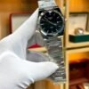 Silver-tone retro style watch with deep black sunburst dial, silver indices, and integrated steel bracelet.