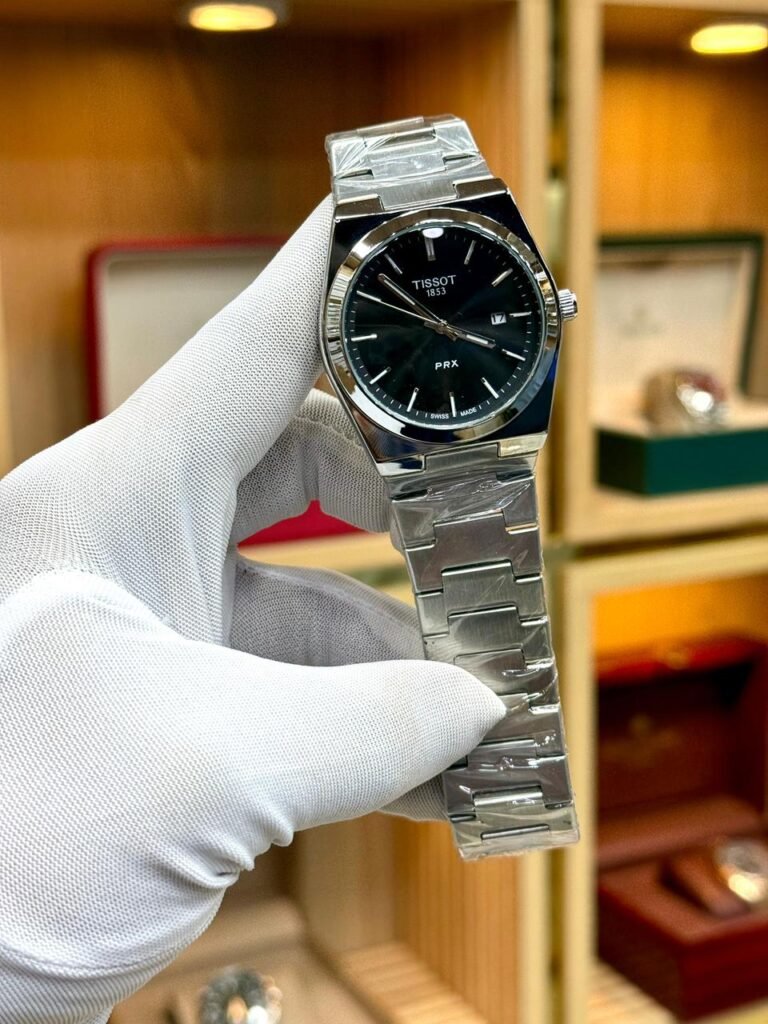 Silver-tone retro style watch with deep black sunburst dial, silver indices, and integrated steel bracelet.