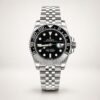 Silver-tone GMT style watch with black dial, black and blue rotating bezel, and jubilee bracelet held in hand.