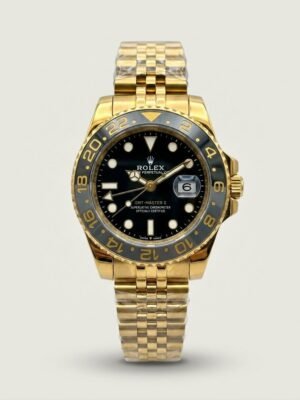 Gold-tone GMT style watch with black dial, black and grey bezel, and gold jubilee bracelet.