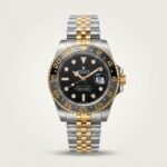 Two-tone silver and gold GMT style watch with black dial, black and grey bezel, and two-tone jubilee bracelet