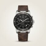 Tubular chronograph watch with black dial, silver-tone case, and brown leather strap.