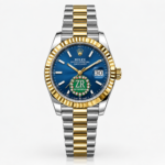 Two-tone ladies luxury watch with blue floral crystal dial, gold fluted bezel, and silver and gold jubilee bracelet.