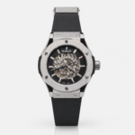 Premium silver-tone skeleton watch with black rubber strap, exposed gears, and six-screw bezel.