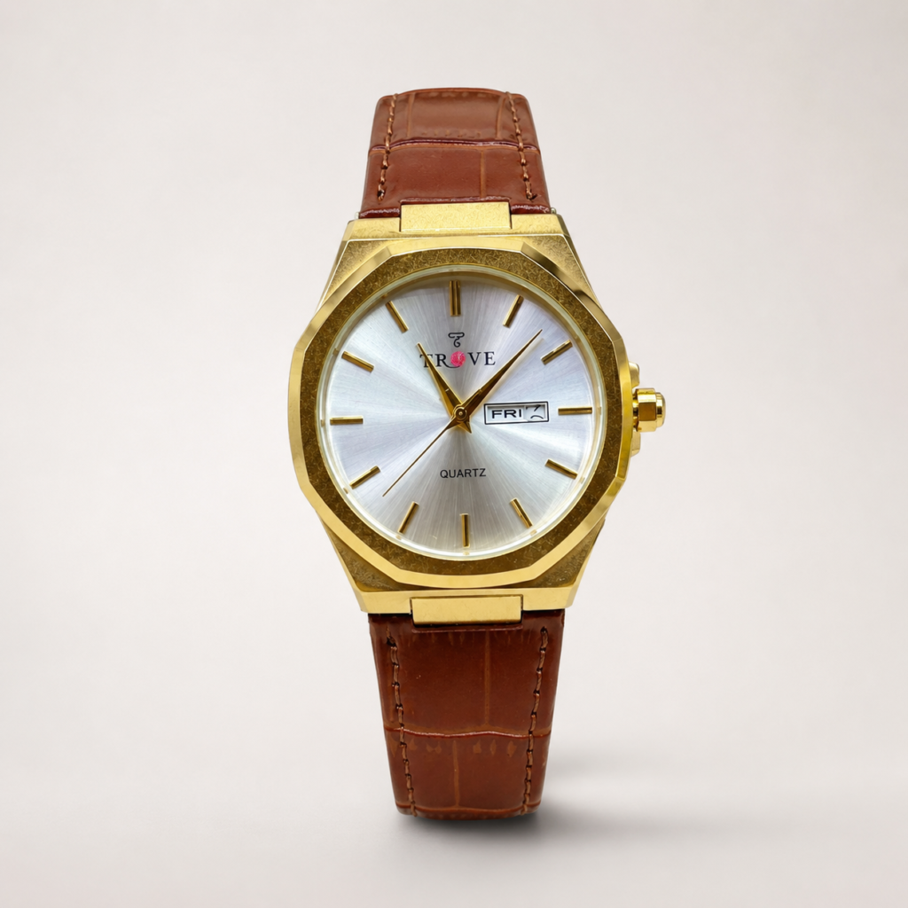 Trove watch with gold case, silver dial, day-date window, and brown leather strap.