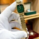 CURREN Blanche women's gold-tone watch with green rectangular dial and stainless steel bracelet.