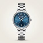 CURREN 9106 women's silver-tone watch with blue sunburst dial and crystal markers.