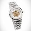Silver skeleton watch with gold movement, white outer ring, and two-tone integrated bracelet.