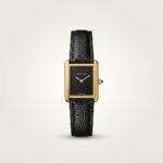 Gold rectangular dress watch with deep black dial, gold hands, and black leather strap.