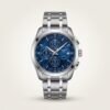 Silver chronograph watch with blue dial and steel bracelet.