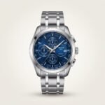 Silver chronograph watch with blue dial and steel bracelet.