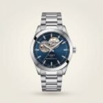 Silver Gentleman style watch with blue sunburst dial, open heart cutout, and stainless steel bracelet.