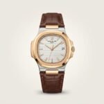 Patex classic watch with silver dial, brown leather strap, and date window.