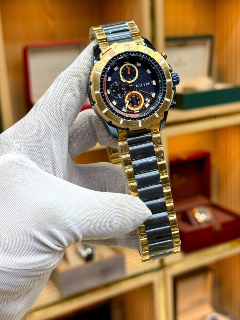EXTRI two-tone sport chronograph watch with black dial, gold steel bracelet, and working sub-dials.