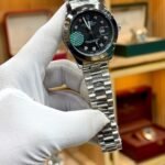 Silver luxury style watch with black dial, crystal hour markers, and silver jubilee bracelet.