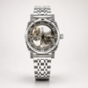 ROVITE automatic skeleton watch with carved silver case, Roman numerals, and steel bracelet.