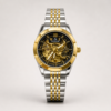 Fitron automatic skeleton watch with black dial, gold-tone case, and two-tone stainless steel bracelet.