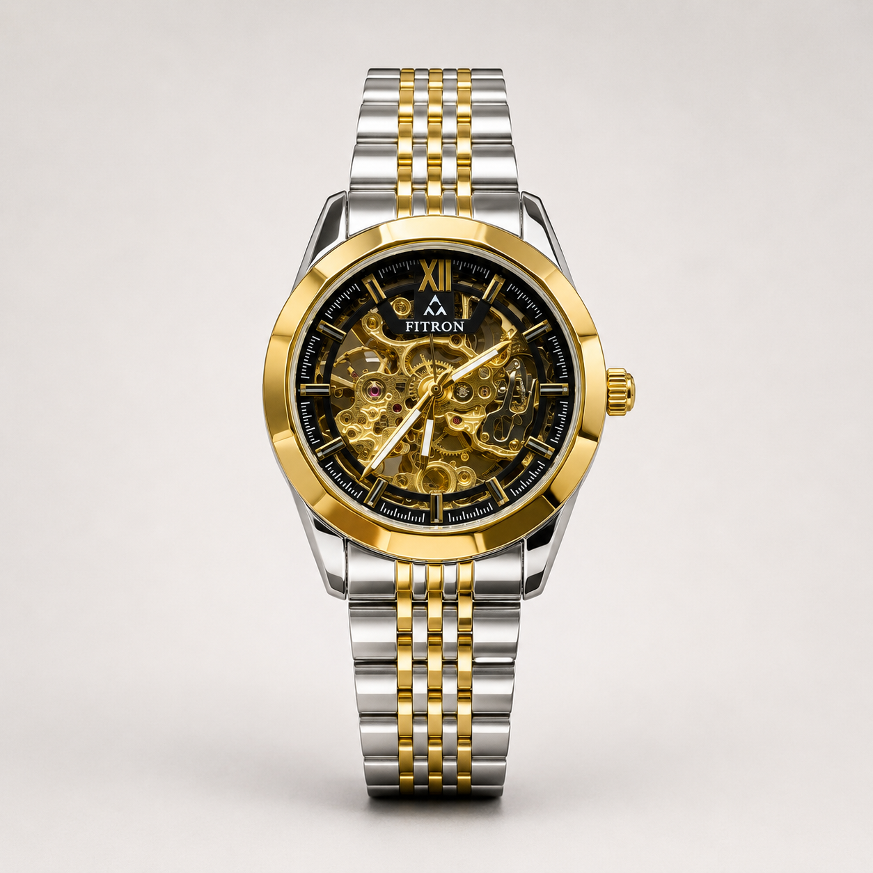 Fitron automatic skeleton watch with black dial, gold-tone case, and two-tone stainless steel bracelet.