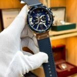 CURREN 8329 chronograph watch with blue dial, rose gold case, and blue leather strap.