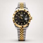Two-tone silver and gold luxury style watch with black dial, crystal markers, gold fluted bezel, day window, and jubilee bracelet.