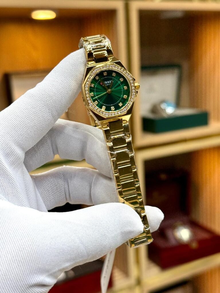 CURREN 9100 women's gold-tone watch with green sunburst dial, crystal markers, and rhinestone bezel.