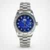 Silver men's luxury watch with blue dial, crystal hour markers, fluted bezel, day-date window, and silver jubilee bracelet.