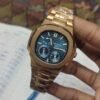 Premium high-grade rose gold automatic watch with blue textured dial, rose gold indices, date window, and rose gold stainless steel bracelet.