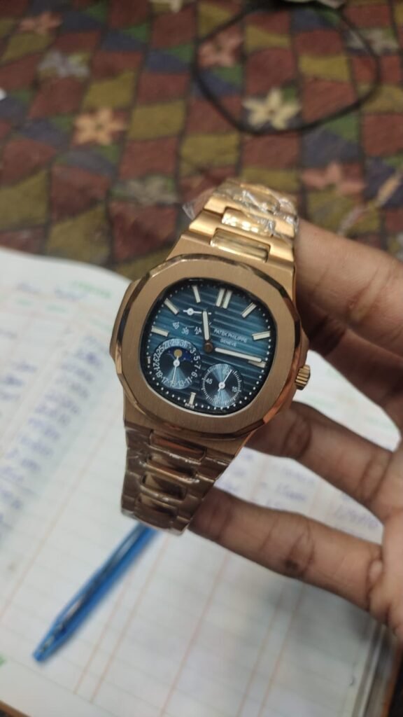 Premium high-grade rose gold automatic watch with blue textured dial, rose gold indices, date window, and rose gold stainless steel bracelet.