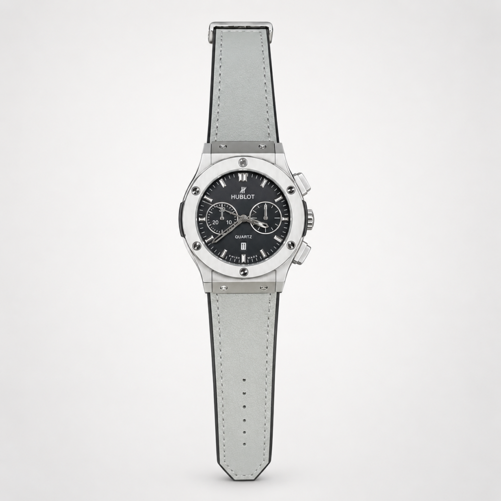 Silver chronograph style watch with black dial, two sub-dials, and grey leather strap.
