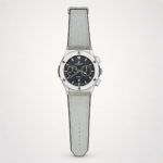 Silver chronograph style watch with black dial, two sub-dials, and grey leather strap.
